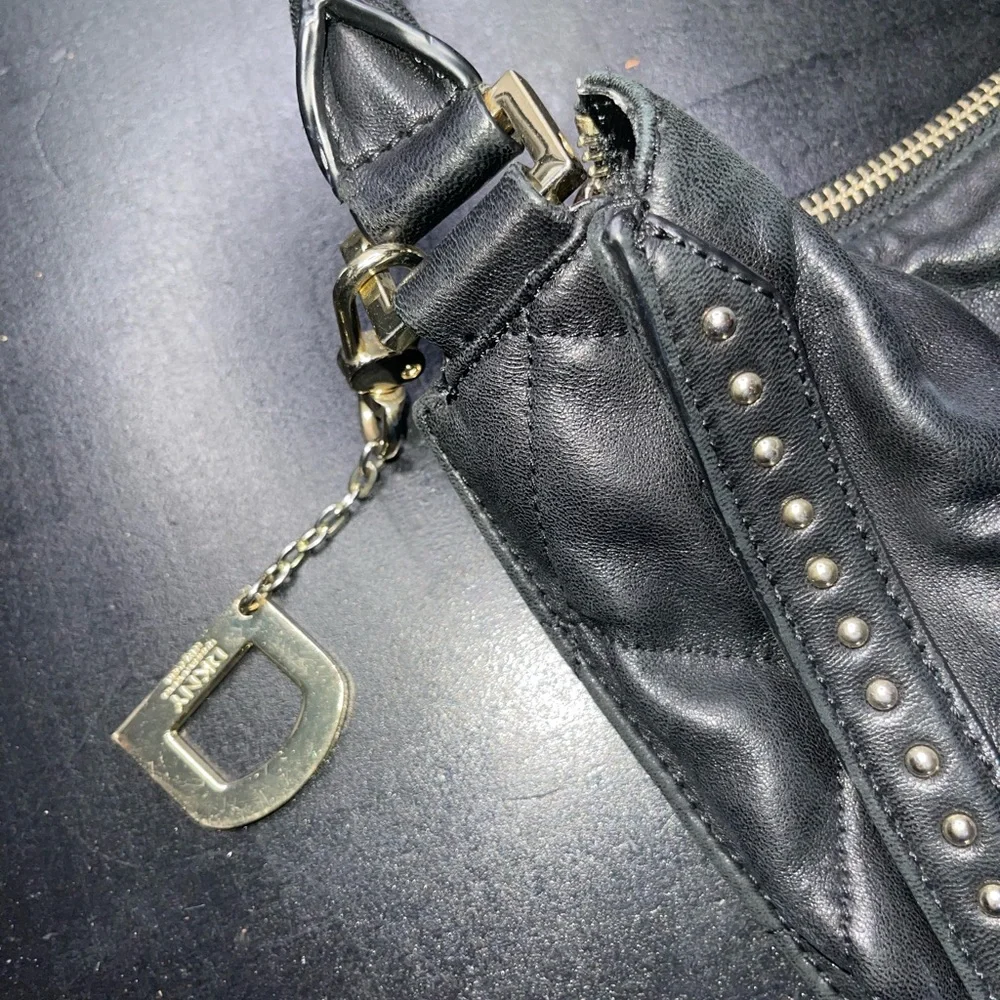 DKNY black leather shoulder bag with stud detailing.